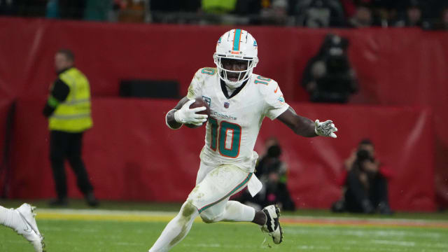 Nov 5, 2023; Frankfurt, Germany; Miami Dolphins wide receiver Tyreek Hill (10) carries the ball against the Kansas City Chiefs in the second half during an NFL International Series game at Deutsche Bank Park. Mandatory Credit: Kirby Lee-USA TODAY Sports  